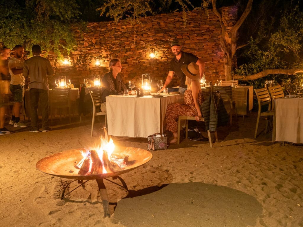 Outdoor boma dining setup under the starlit African sky